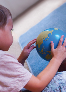 Child looking at globe